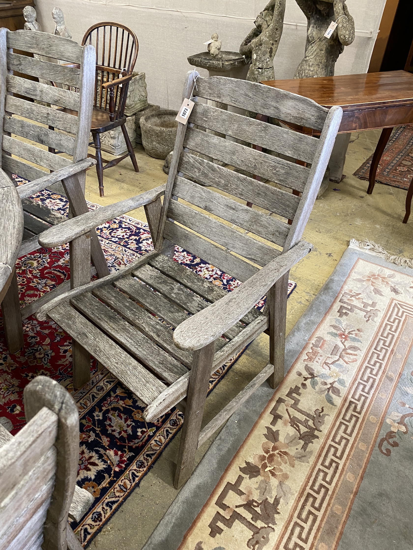 Lazy Dayz, New Zealand, a circular teak garden table, diameter 180cm, height 72cm and eight elbow chairs